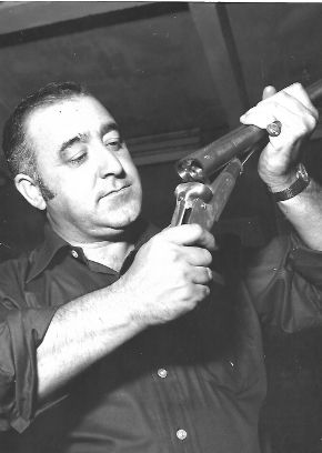 Checking a gun in the workshop.